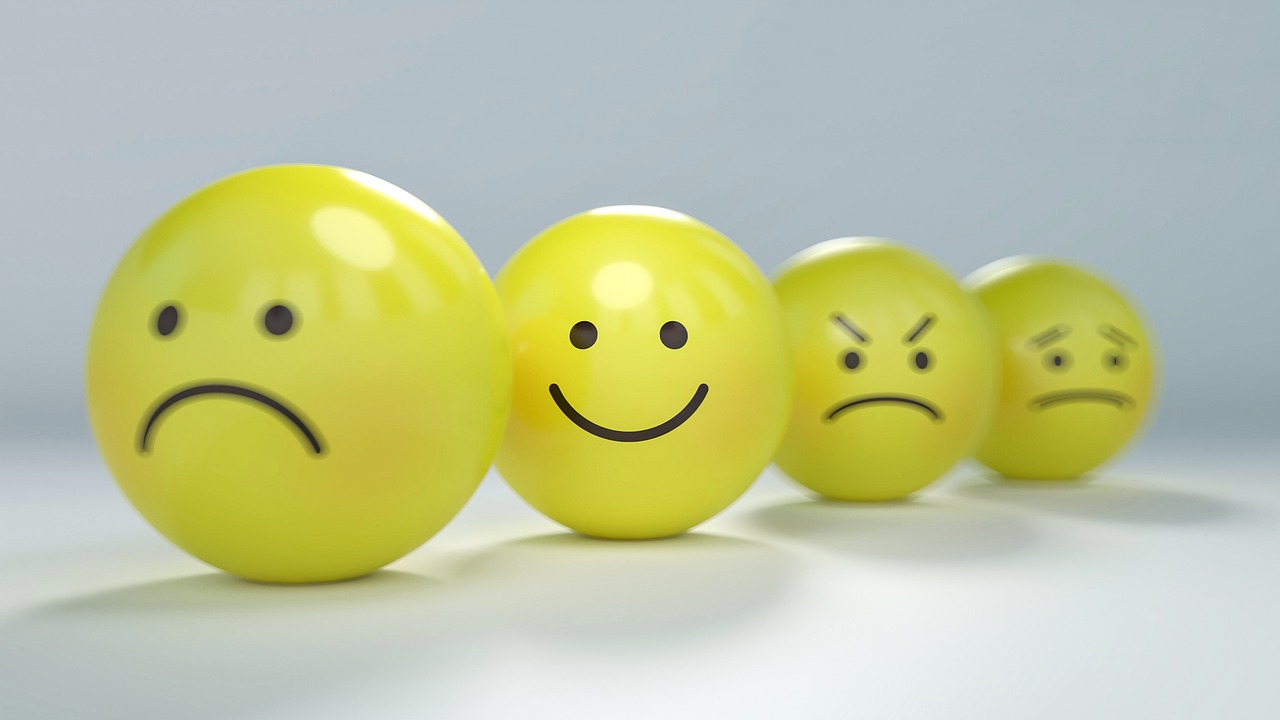 Balls with sad to happy faces displaying various emotions