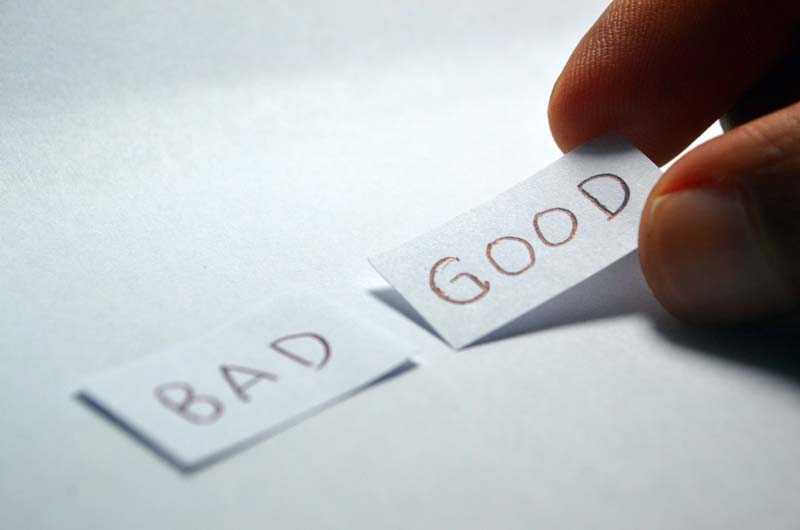 two pieces of paper laid side by side with one saying good and one saying bad two pieces of paper laid side by side with one saying good and one saying bad