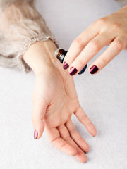 woman applying an essential oil to her skin