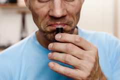 man smelling essential oils